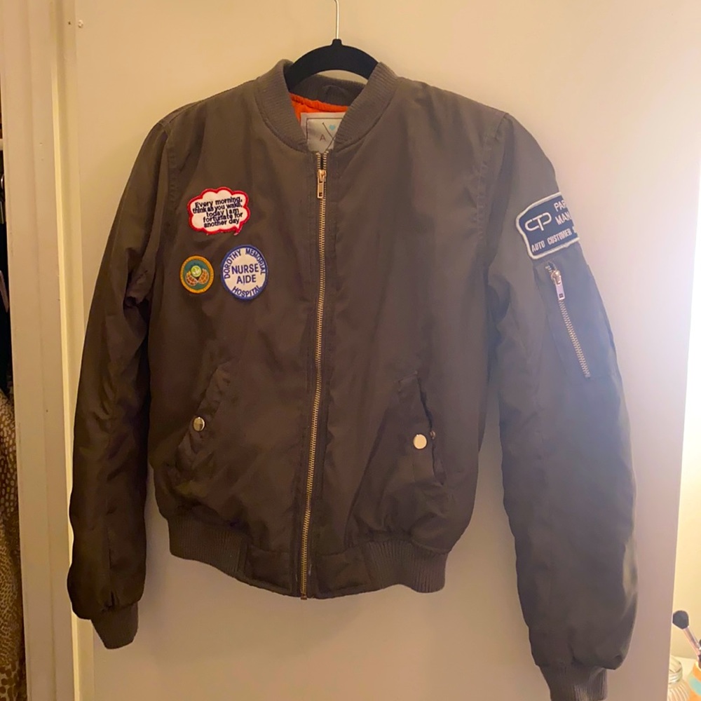 Deep olive green bomber jacket . Orange inside and super cozy and warm.